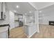 Modern kitchen featuring stainless steel appliances, white cabinetry, a kitchen island, and hardwood floors at 45 Nimble Way # 180, Clayton, NC 27520