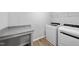 Bright laundry room featuring modern washer and dryer, granite countertops, and ample storage space at 45 Nimble Way # 180, Clayton, NC 27520