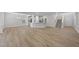 Expansive living space with wood floors, modern lighting, breakfast bar, and stairs leading to upper level at 45 Nimble Way # 180, Clayton, NC 27520