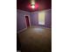 Carpeted bedroom featuring lots of natural light with a large window and closet at 614 Tucker St, Burlington, NC 27215