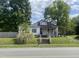 Charming single-story home with a classic front porch and a cozy, welcoming feel on a partially cloudy day at 614 Tucker St, Burlington, NC 27215