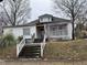 Charming single-story home with a covered front porch and landscaped front yard at 614 Tucker St, Burlington, NC 27215