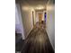 Hallway featuring hard surface floors and neutral paint providing a clean and modern aesthetic at 614 Tucker St, Burlington, NC 27215