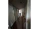 Hallway with wood laminate flooring leading to other rooms, with neutral paint at 614 Tucker St, Burlington, NC 27215