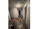 Bright hallway with newly installed wood flooring, offering a view through to a bathroom and the rest of the home at 614 Tucker St, Burlington, NC 27215