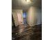 Bright hallway with wood flooring shows an open door to the bathroom and to the rest of the home beyond at 614 Tucker St, Burlington, NC 27215