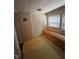 Modest room featuring natural light from window, with a built-in wooden bench against the wall, ready to be updated at 614 Tucker St, Burlington, NC 27215