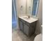 Stylish bathroom vanity featuring a white countertop, gray cabinets, a chrome faucet, and matching hardware at 65 Watermelon Dr, Franklinton, NC 27525