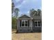 Charming home exterior featuring stone accents, gray siding, black shutters, and well-maintained landscaping at 65 Watermelon Dr, Franklinton, NC 27525