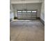 Clean and spacious garage with a concrete floor, white walls, and an insulated garage door at 65 Watermelon Dr, Franklinton, NC 27525