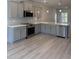 Stylish kitchen with stainless steel appliances, quartz counters, and grey cabinets at 65 Watermelon Dr, Franklinton, NC 27525
