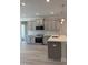 Well-lit kitchen featuring grey cabinets, quartz counters, and an island at 65 Watermelon Dr, Franklinton, NC 27525
