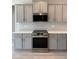 Modern kitchen with stainless steel appliances and grey cabinets at 65 Watermelon Dr, Franklinton, NC 27525