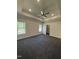 Spacious main bedroom with tray ceiling, carpet, and walk-in closet at 65 Watermelon Dr, Franklinton, NC 27525