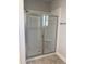 Modern glass-enclosed shower stall with white subway tile surround and a built-in shower seat at 65 Watermelon Dr, Franklinton, NC 27525