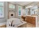 Spa-like bathroom featuring a large soaking tub and double vanity at 6729 Greywalls Ln, Raleigh, NC 27614
