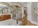 Elegant bathroom with soaking tub, walk-in shower, and hardwood floors at 6729 Greywalls Ln, Raleigh, NC 27614