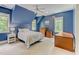 Serene bedroom featuring blue walls, large windows, and ample closet space at 6729 Greywalls Ln, Raleigh, NC 27614