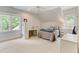 Bright bedroom with a comfy bed, built-in shelving, and plenty of natural light at 6729 Greywalls Ln, Raleigh, NC 27614