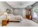 Spacious bedroom with wood dresser and large window at 6729 Greywalls Ln, Raleigh, NC 27614