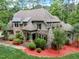 Stone and brick house with a large yard and mature trees at 6729 Greywalls Ln, Raleigh, NC 27614