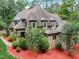 Brick and stone house with a gabled roof and manicured landscaping at 6729 Greywalls Ln, Raleigh, NC 27614
