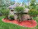 Brick house with stone accents, red mulch beds, and lush lawn at 6729 Greywalls Ln, Raleigh, NC 27614