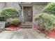 Brick front entrance with arched wooden door and stone accents at 6729 Greywalls Ln, Raleigh, NC 27614
