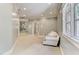 Long hallway with light walls and a comfortable seating area at 6729 Greywalls Ln, Raleigh, NC 27614