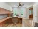 Bright home office features built-in cabinetry and hardwood floors at 6729 Greywalls Ln, Raleigh, NC 27614