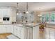 Spacious kitchen with granite countertops, stainless steel appliances, and custom cabinetry at 6729 Greywalls Ln, Raleigh, NC 27614