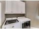Laundry room with white cabinets and matching washer/dryer at 6729 Greywalls Ln, Raleigh, NC 27614
