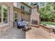 Outdoor patio with a brick fireplace, seating area, and stamped concrete at 6729 Greywalls Ln, Raleigh, NC 27614