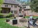 Stone patio with fire pit, seating area, and string lights at 6729 Greywalls Ln, Raleigh, NC 27614