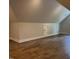 Large attic space featuring hardwood floors, a neutral color palette, and bonus storage at 716 Spirit Hill Dr, Hillsborough, NC 27278