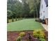 Spacious backyard with lush green grass and meticulously maintained landscaping at 716 Spirit Hill Dr, Hillsborough, NC 27278