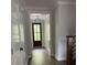 Elegant entryway featuring hardwood floors, shiplap walls, and a stylish dark front door at 716 Spirit Hill Dr, Hillsborough, NC 27278