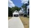 Charming two-story home with white siding, black accents, and well-manicured lawn at 716 Spirit Hill Dr, Hillsborough, NC 27278