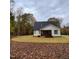 Charming exterior view of a home with a screened porch, surrounded by the vibrant colors of fall foliage at 716 Spirit Hill Dr, Hillsborough, NC 27278