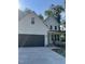 Beautiful two-story home with a black garage door, white exterior, covered porch, and stylish landscaping at 716 Spirit Hill Dr, Hillsborough, NC 27278
