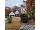 Charming two-story home with white siding, black roof and trim, and a well-manicured lawn in a serene setting at 716 Spirit Hill Dr, Hillsborough, NC 27278