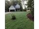 Beautifully landscaped front yard featuring lush green grass and a charming white home at 716 Spirit Hill Dr, Hillsborough, NC 27278
