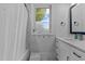 Well-lit bathroom with tub and shower featuring modern vanity and fixtures with a window at 727 Martin Luther King Jr Blvd Blvd, Raleigh, NC 27601