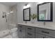 Elegant bathroom featuring double vanities, a glass-enclosed shower, and modern fixtures at 727 Martin Luther King Jr Blvd Blvd, Raleigh, NC 27601