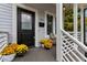 Charming front porch featuring yellow mums and a cozy seating area at 727 Martin Luther King Jr Blvd Blvd, Raleigh, NC 27601