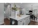 Kitchen island with gray cabinetry, white countertops, and seating for three to the adjacent dining area at 727 Martin Luther King Jr Blvd Blvd, Raleigh, NC 27601
