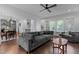 Inviting living room with hardwood floors, modern ceiling fan and large windows with natural light at 727 Martin Luther King Jr Blvd Blvd, Raleigh, NC 27601