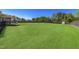 Expansive backyard featuring a lush lawn, mature trees, and a cozy deck area for outdoor relaxation at 7945 Parker Mill Trail, Fuquay Varina, NC 27526