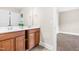 Bathroom featuring a double sink vanity with white countertops, wood cabinets, and neutral walls at 7945 Parker Mill Trail, Fuquay Varina, NC 27526