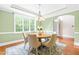 Cozy dining room with a chandelier, large window, and access to the foyer at 7945 Parker Mill Trail, Fuquay Varina, NC 27526